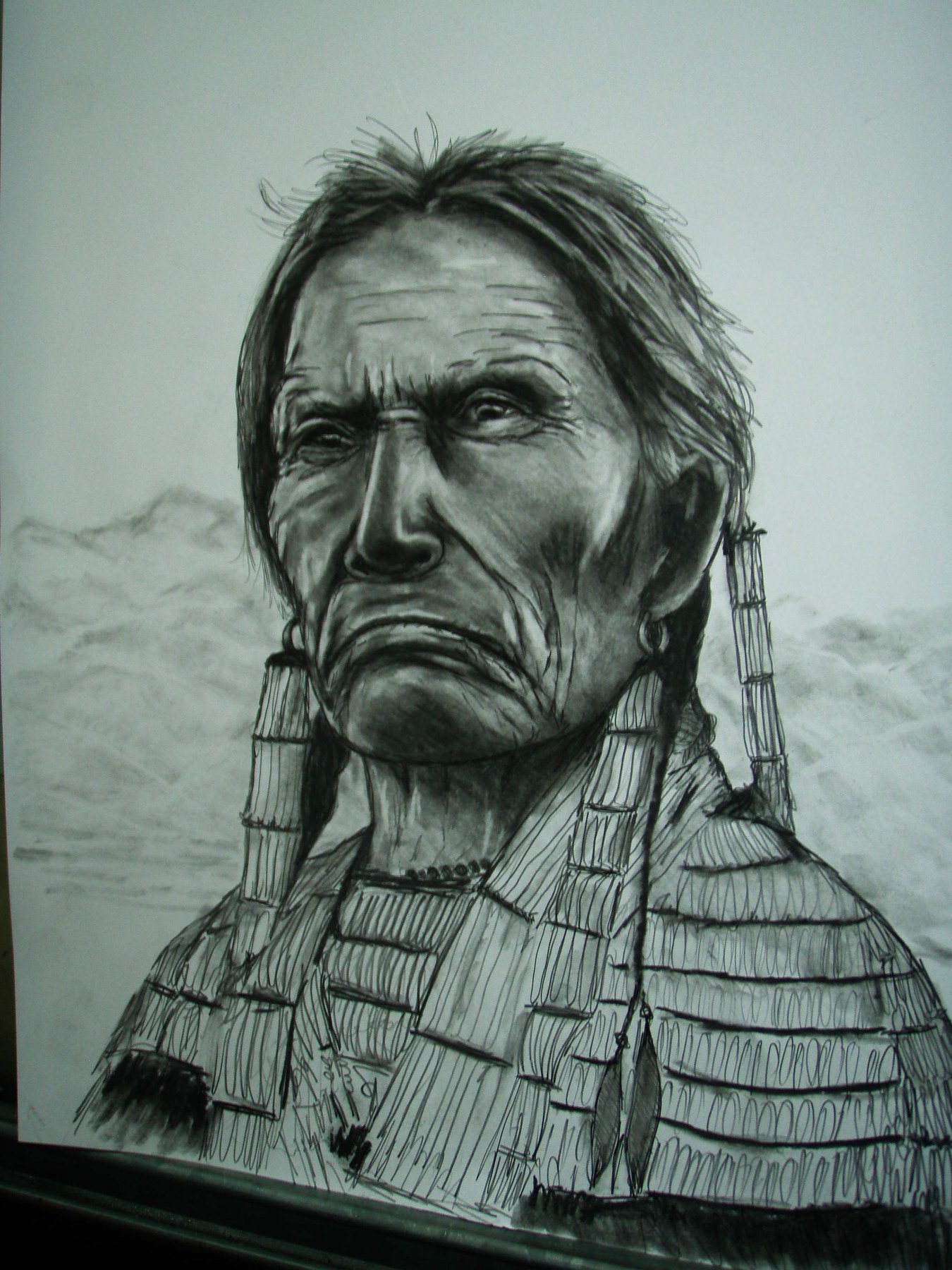 Pencil portrait of a man wearing a patterned headscarf